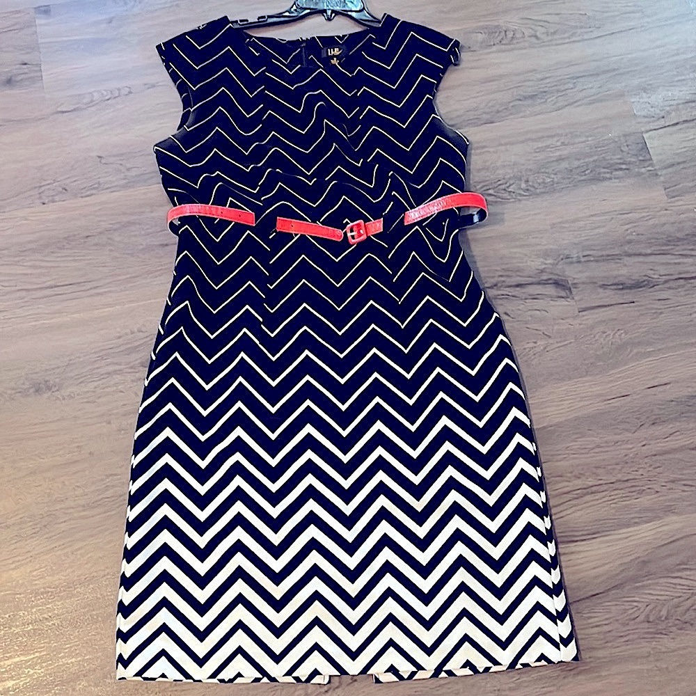 Black & white chevon style design sleeveless dress with pink belt. Super cute.